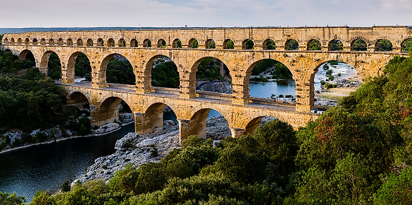 The multiple arches of the Pont du Gard in Roman Gaul (modern-day southern France). The upper tier encloses an aqueduct that carried water to Nimes in Roman times; its lower tier was expanded in the 1740s to carry a wide road across the river.