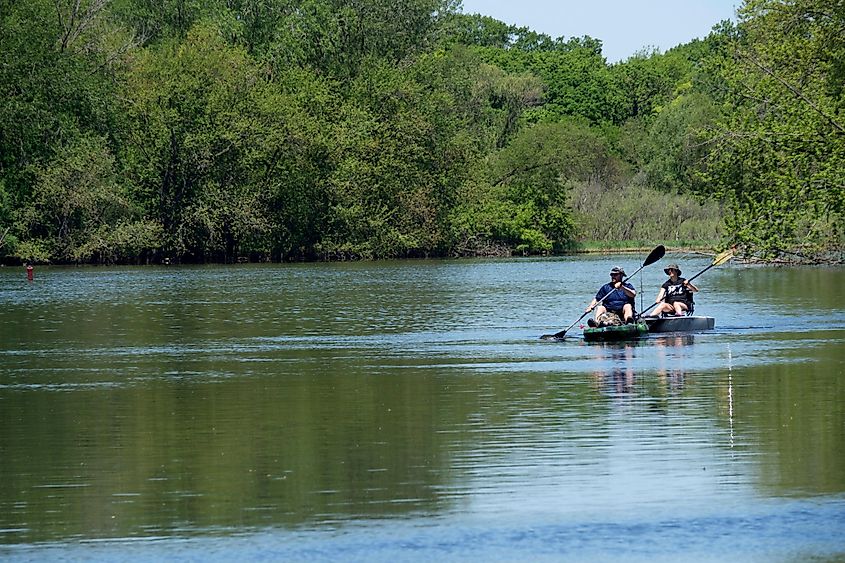 People kayaking in a calm river in Crystal Lake