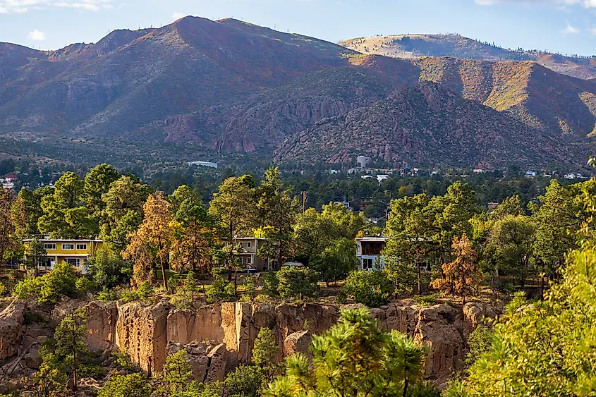 Residential panorama of Los Alamos, New Mexico, with canyon and mountains beyond.