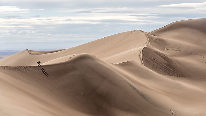 Hikers are dwarfed by the immense dunes at Great Sand Dunes National Park.