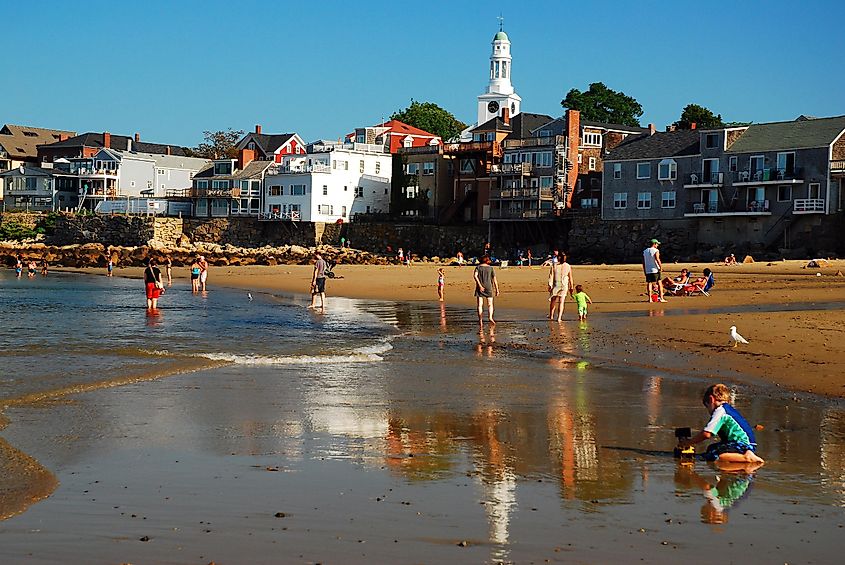 Families enjoy a summer day on Front Beach, just steps from downtown Rockport, Massachusetts, USA.