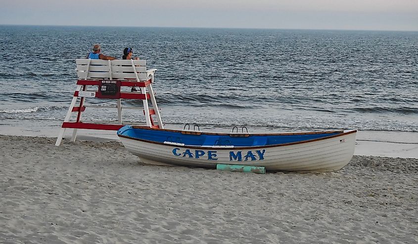 unset at Cove Beach while vacationing at Cape May, Shows a boat reading "Cape May"