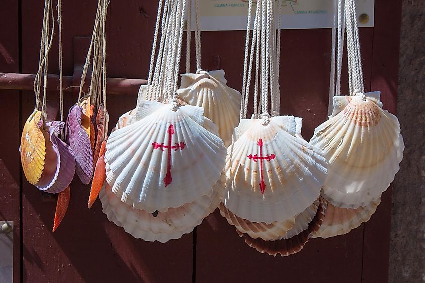 Various hanging scallop shells decorated in red paint by the Christian cross - signifying the Camino de Santiago pilgrimage.  
