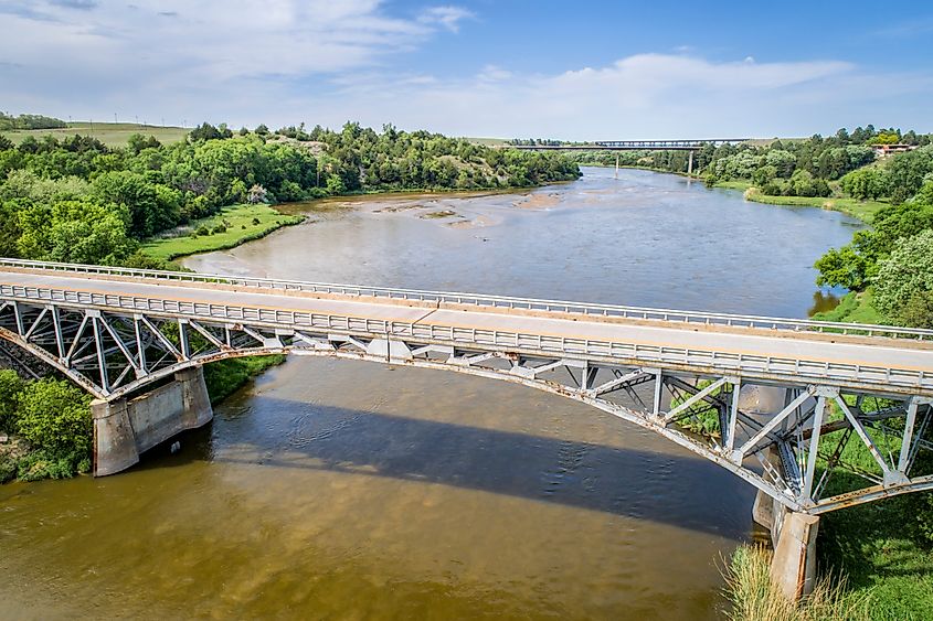 Niobrara River with a historic pin-connected arch Bryan bridge built in 1932 near Valentine in Nebraska Sandhills, aerial perspective.