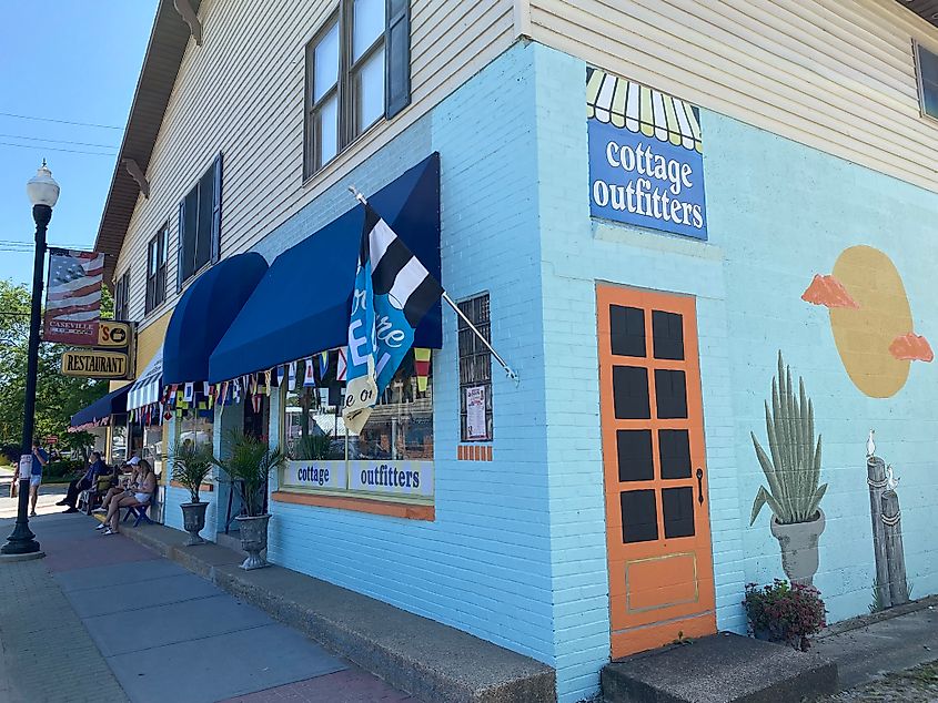 A bright mural welcomes sidewalk shoppers to Cottage Outfitters.