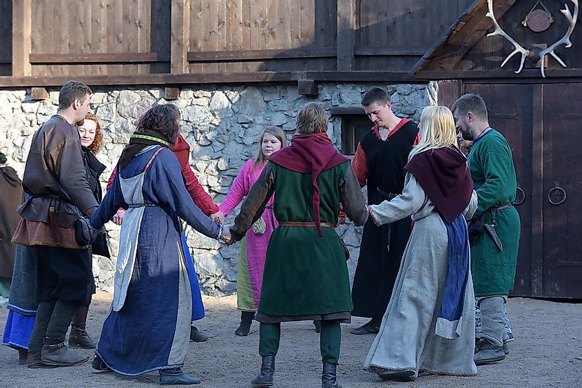 People performing the Medieval dance of Carole at the historical May Tree festival in Vyborg, Russia.