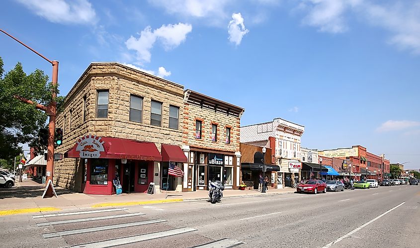 Downtown street in Cody, Wyoming with cars and people.