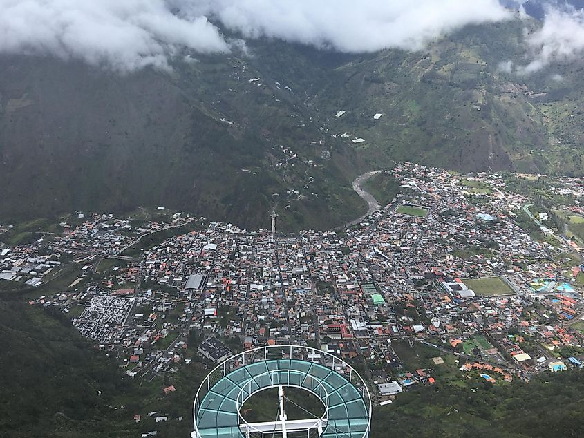 A glass mountainside platform overlooking a town far below