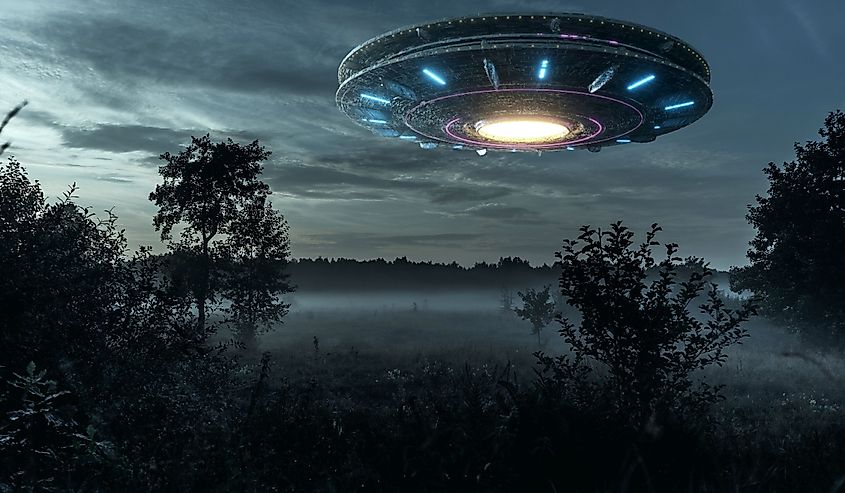 UFO, an alien plate hovering over the field, hovering motionless in the air.
