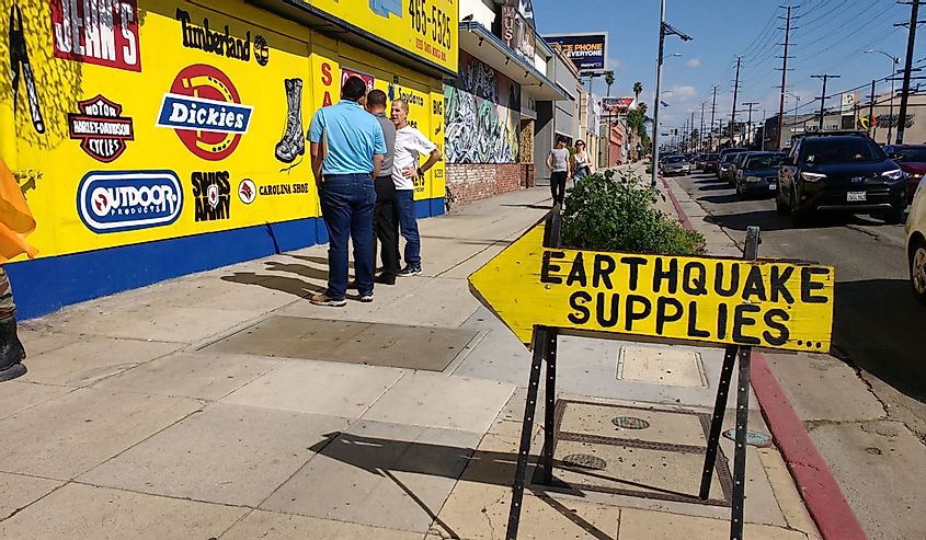 An arrow saying "Earthquake Supplies" points to a survival and earthquake preparedness store in Los Angeles, California.