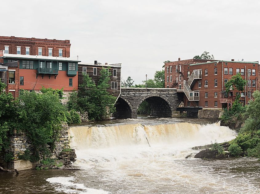 Middlebury Falls, a scenic waterfall located in Middlebury, Vermont, surrounded by lush greenery.