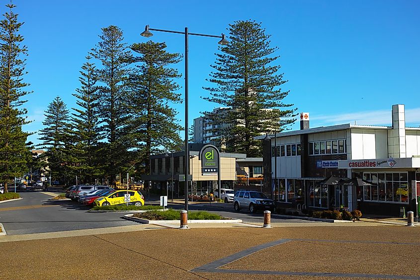 City centre street with a hotel, apartment buildings and shops in the coastal holiday town of Port Macquarie.