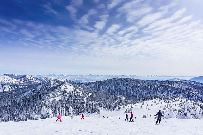 A group of skiers in the scenic alpine landscape of Whitefish, Montana