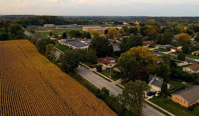 Aerial view typical suburban street. Residential houses, agricultural field from above. Autumn Fall scenery, Rural landscape. Grafton, Wisconsin