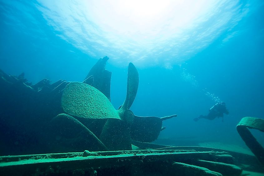 A lone diver exploring a shallow shipwreck 