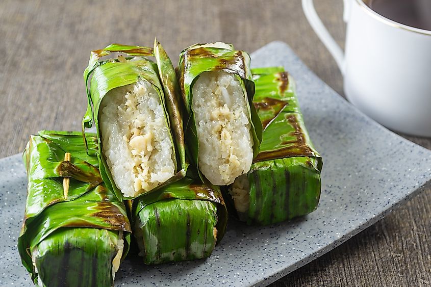 Traditional Indonesian snack of Lemper Ayam bakar asavory steamed glutinous sticky rice filled with seasoned shredded chicken, wrapped and grilled in banana leaves