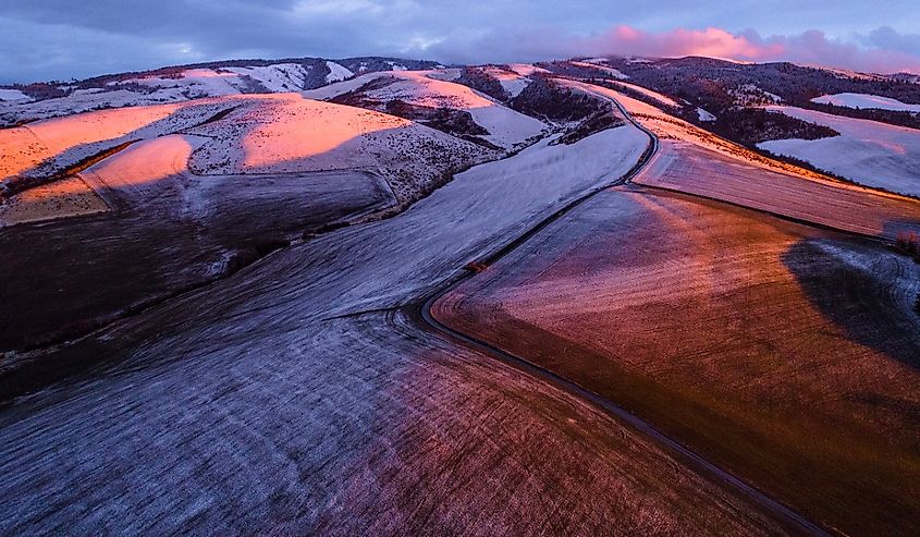 An aerial photo of sunset lighting the foothills of the Blue Mountains in pink near Walla Walla, Washington.