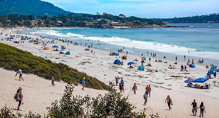 People flock to Carmel Beach during an early season heat wave