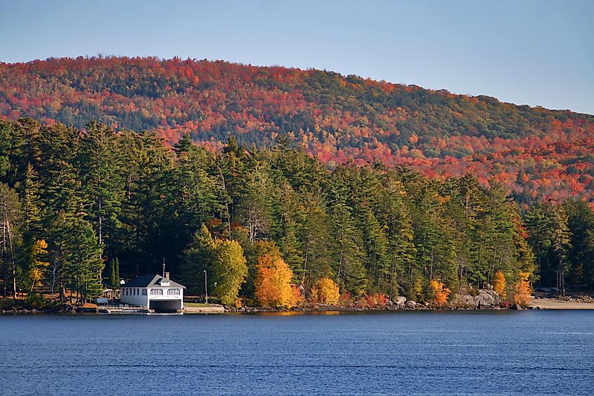 A boat house among fall foliage on Schroon Lake, NY