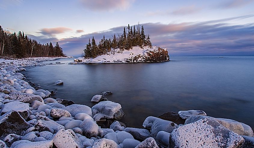 Snow covered island on Lake Superior during sunset