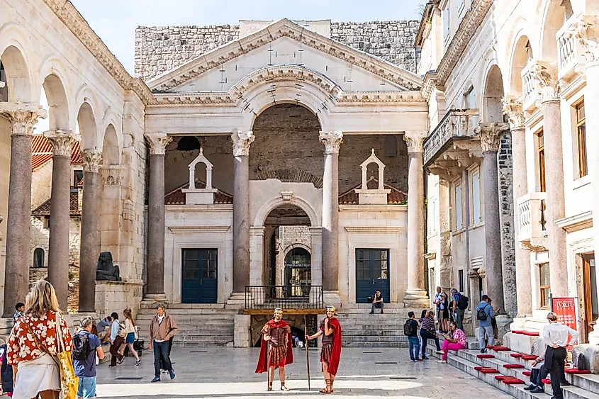Split, Croatia: Tourists and Roman soldiers at the Peristyle, with a view of Diocletian's Palace in the historic center of Split.