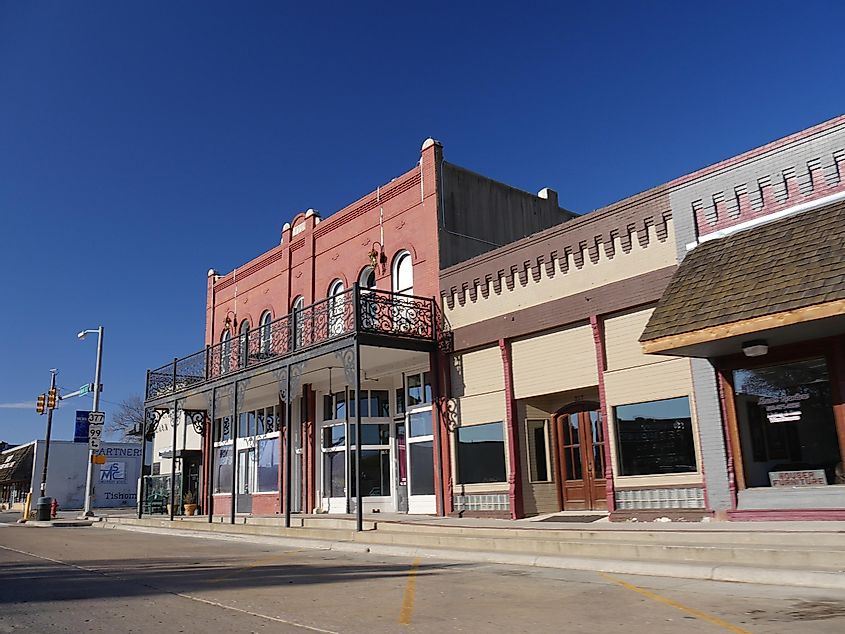 Some of the old buildings along the main street of Tishomingo, the largest city in the Johnson County of Oklahoma, via RaksyBH / Shutterstock.com