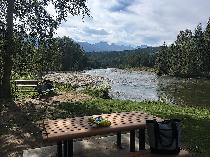 A picnic table overlooking a beautiful river.