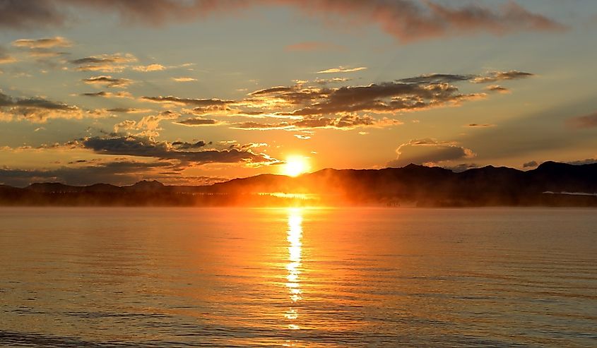 Sunrise at Yellowstone Lake - A late August morning, the sun rises over the foggy Yellowstone Lake, Yellowstone National Park, Wyoming,