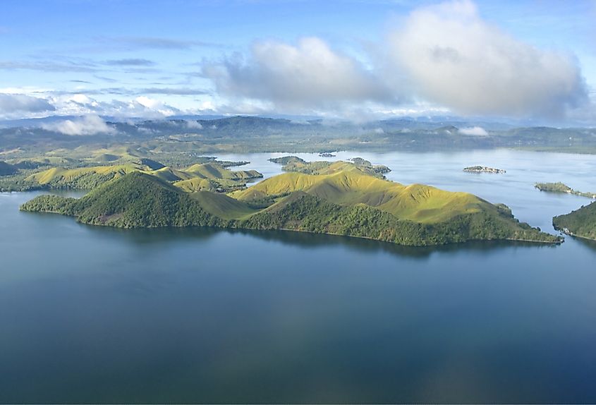  An aerial photo capturing the coast of New Guinea, showcasing the lush jungles and areas affected by deforestation.