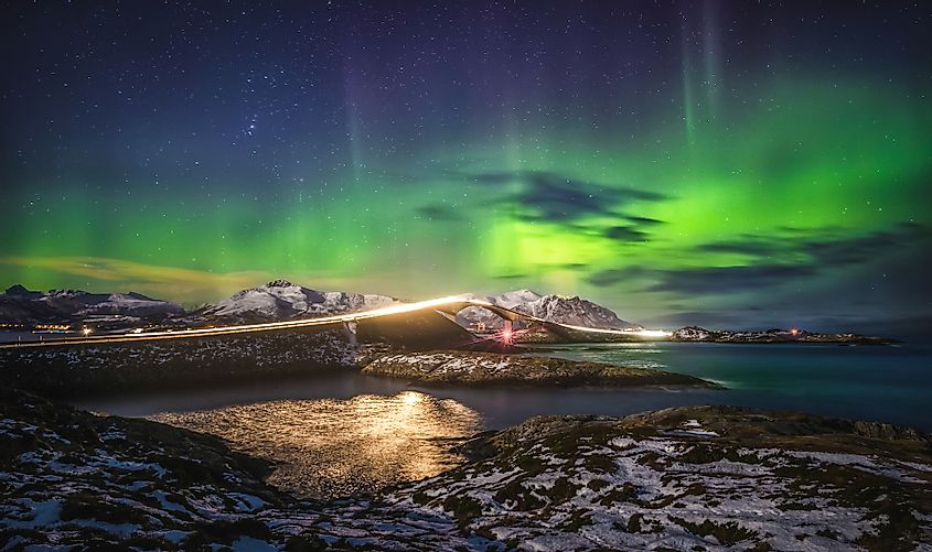 Amazing night sky with Aurora Borealis over Atlantic Ocean Road in Norway. 