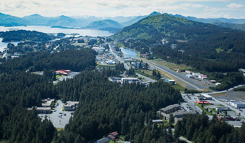 aerial view of the town of Kodiak Alaska with evergreens and mountains