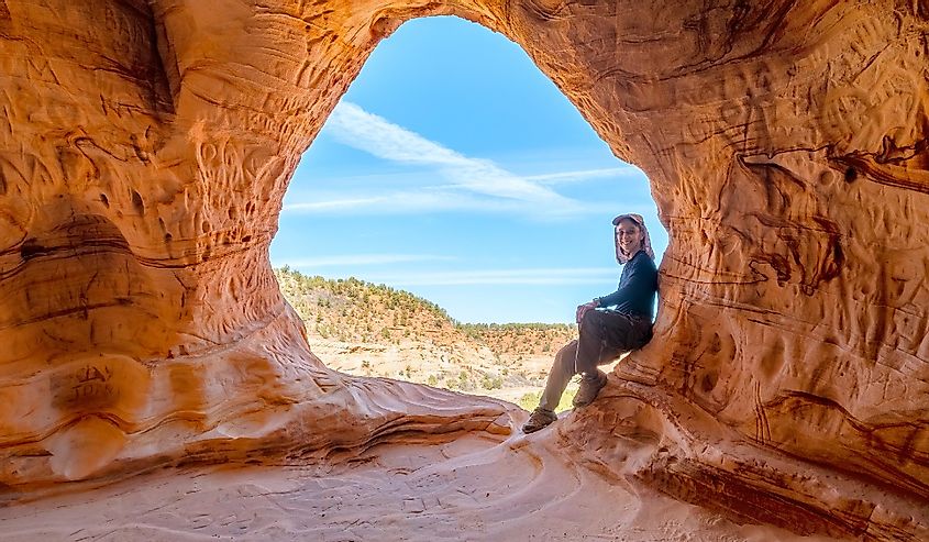 Person posing at the man-made Sand Caves, Kanab, Utah
