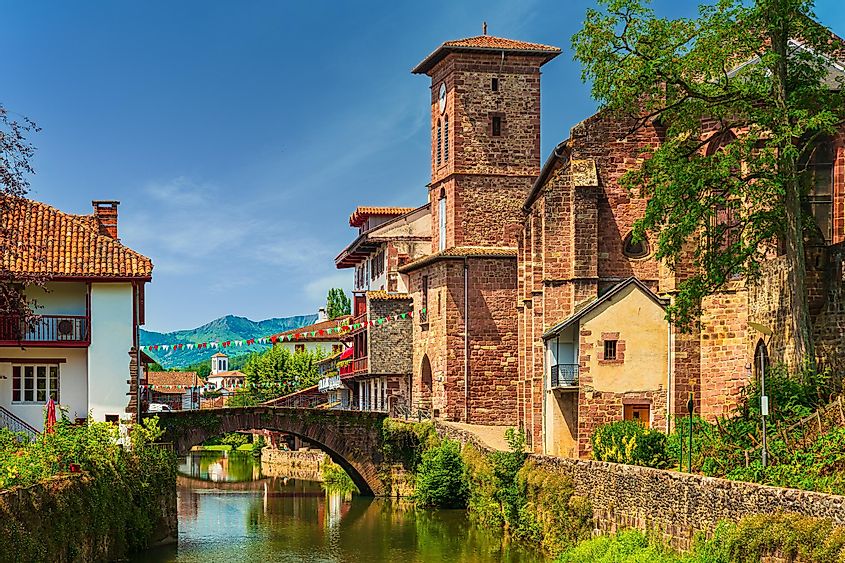 The small, riverside French village of St.-Jean-Pied-de-Port. A medieval stone bridge can be seen arcing over the modest river. 