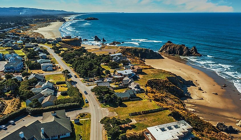 Aerial drone shot of coastal homes and beach in Bandon, Oregon.