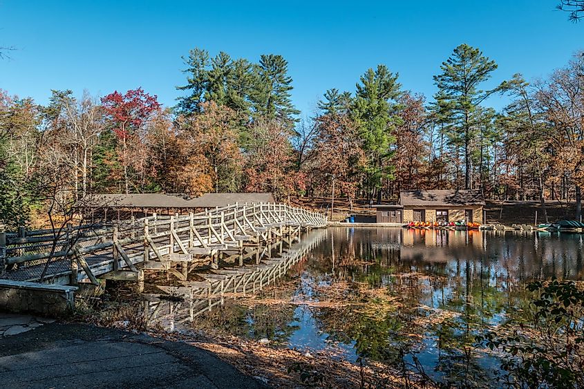 Crossing over the wooden bridge across from the boat rentals on Byrd Lake in Cumberland Mountain State Park