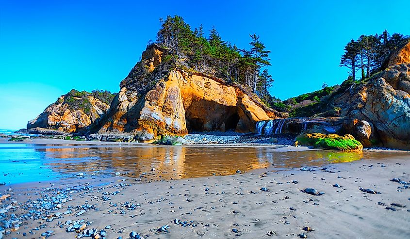 Hug Point waterfalls visible and can be reached at low tide at near Cannon Beach, in Oregon, USA