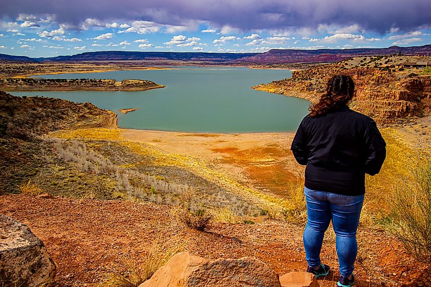 A young woman looking at a beautiful view of the Abiquiu Lake, New Mexico
