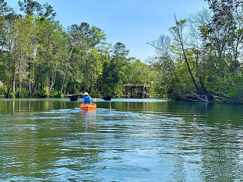 A kayaker in the river in Magnolia Springs, Alabama