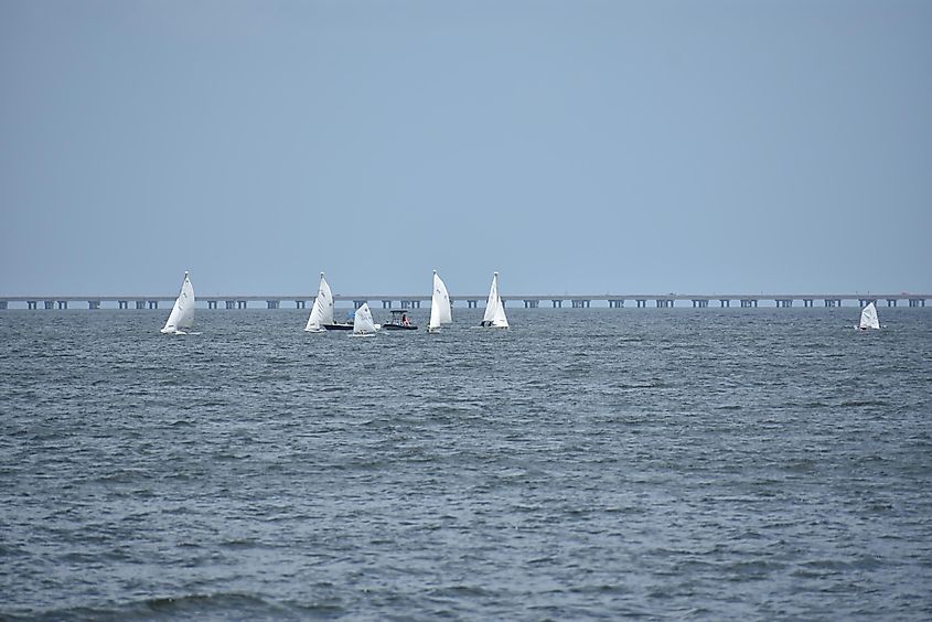A fleet of sailboats enjoy the challenge of exploring Lake Pontchartrain on a warm, sunny day in New Orleans