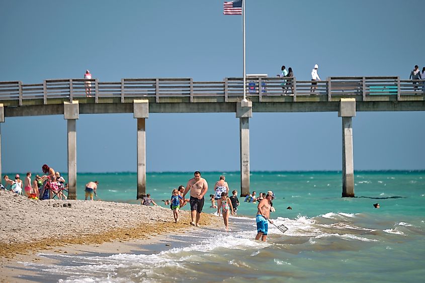 People enjoying their time at a beach in Venice, Florida. Editorial credit: Bilanol / Shutterstock.com.