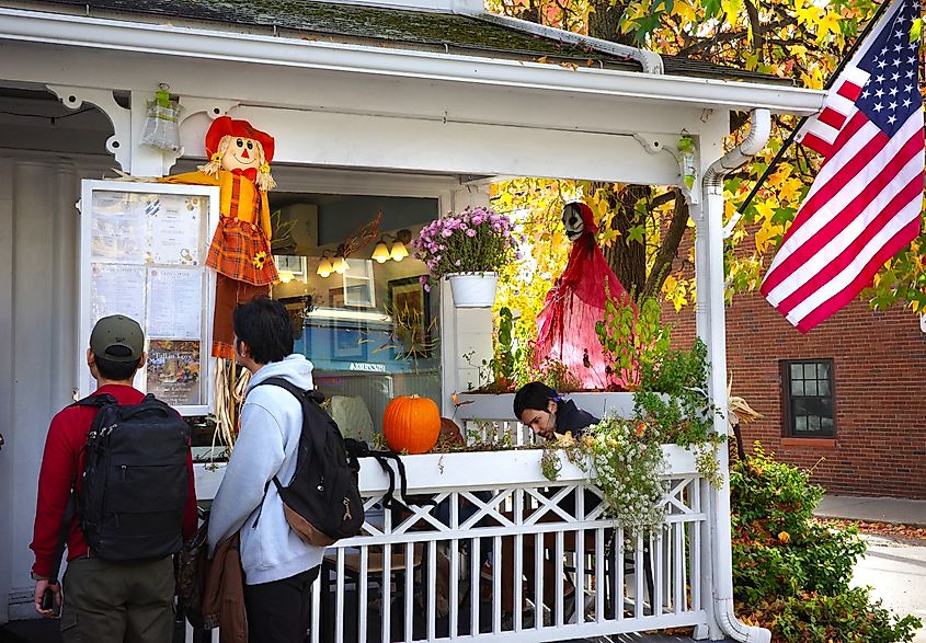 People inspecting the menu outside a restaurant in Cold Spring, New York.