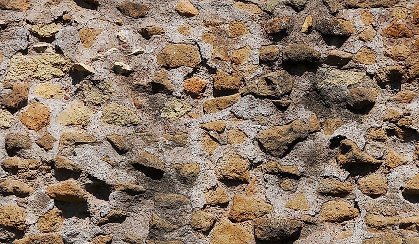 'opus caementicium' (Ancient Roman concrete) style wall ruins as background