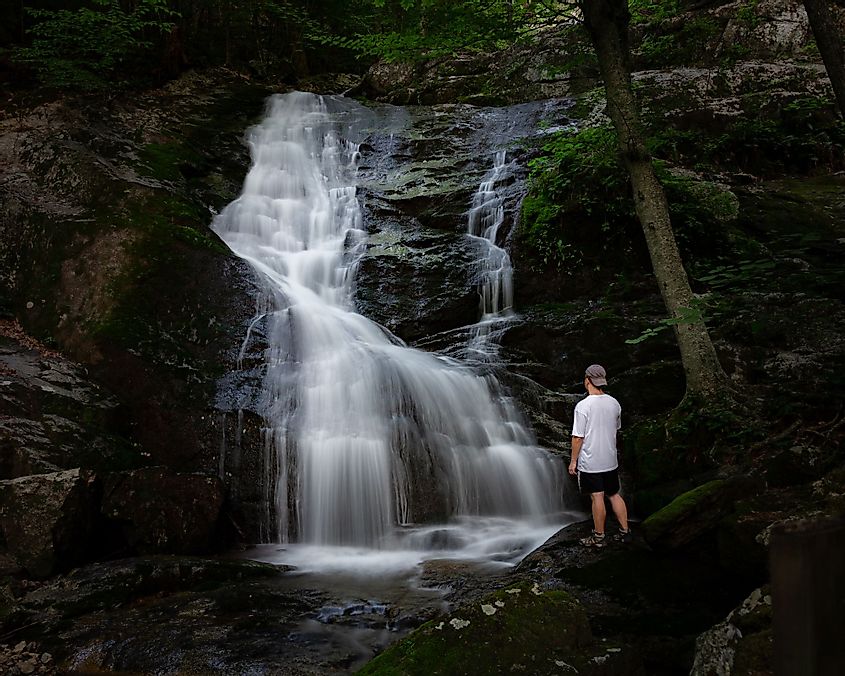 A man standing near the Crabtree Falls in Blue Ridge Parkway