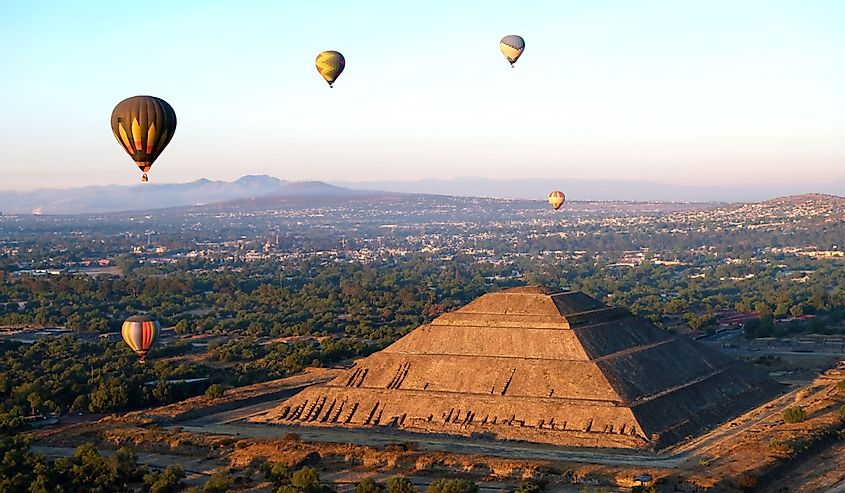 Aerial view at Maya Pyramid of the Sun and Moon at Teotihuacan, Mexico at sunrise with hot air balloons above