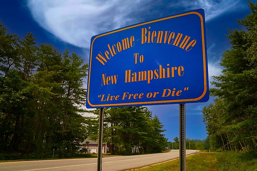 Welcome Bienvenue to New Hampshire highway sign, bearing the state's iconic motto Live Free or Die. Via Shutterstock / Nia Dadara