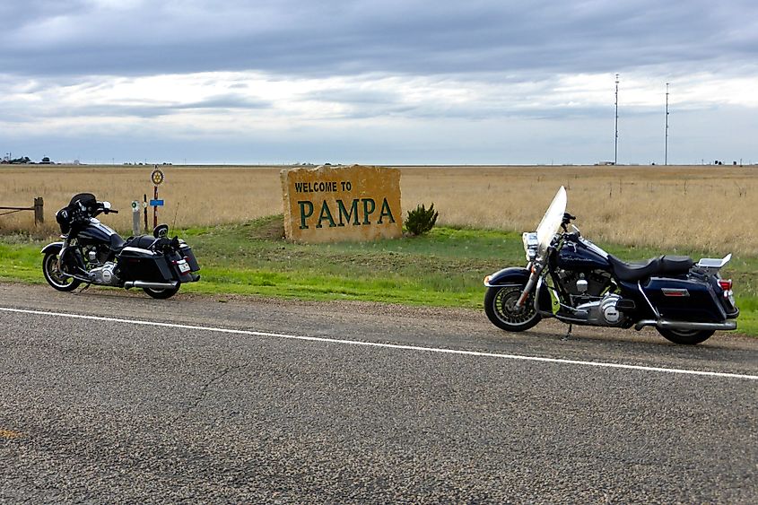 Two Harley Davidson Motorcycles by The Welcome to Pampa Sign