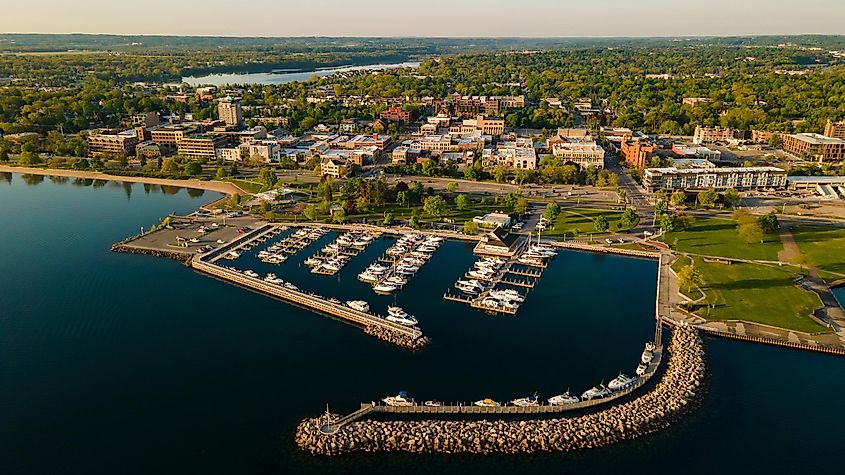 A boat marina on a lake with boats moored at the docks.