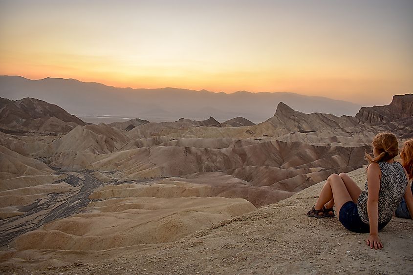 Woman admiring sunset at Zabriske Point, Death Valley National Park, California.