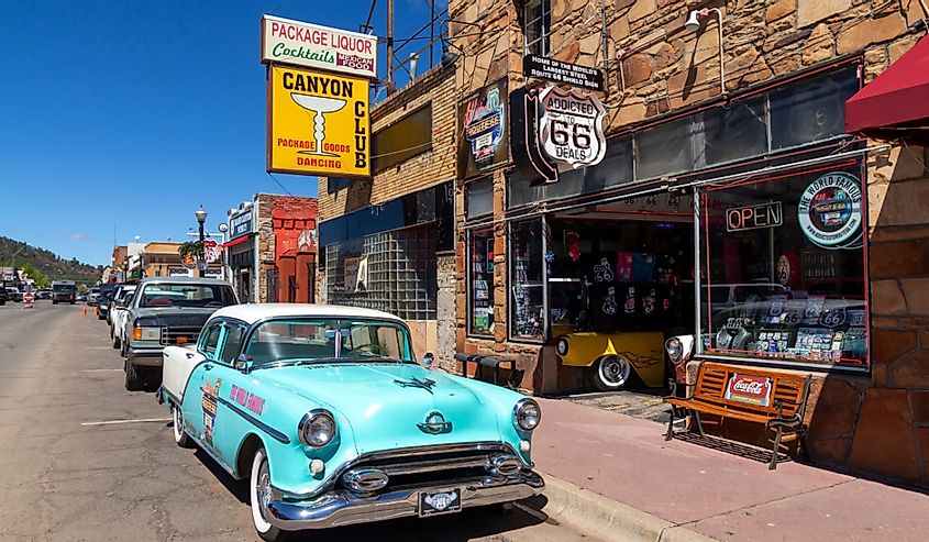Street scene with a classic car in front of souvenir shops in Williams, Arizona.