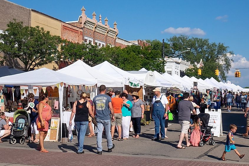 Crowds on a sunny day enjoying an art fair on Main Street in Howell, Michigan. Image credit NCSchneider_Images via Shutterstock